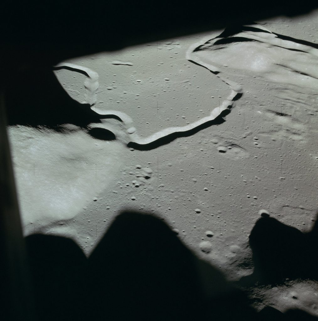 View of landing site from the window of the Lunar Module, taken on the orbit prior to landing (13th). From a sequence of images taken by Dave Scott during orbit, SEVA, and EVA 1.